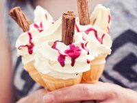 Girl-holding-three-ice-cream-cones-with-raspberry-sauce.jpg